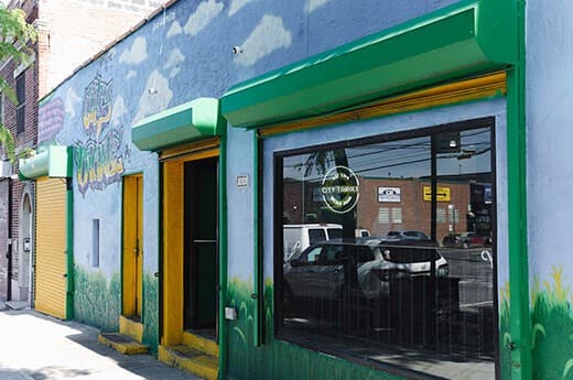 The green and yellow City Tamale storefront on Oak Point Avenue in Hunts Point