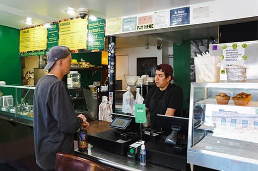 A customer being served at the City Tamale counter